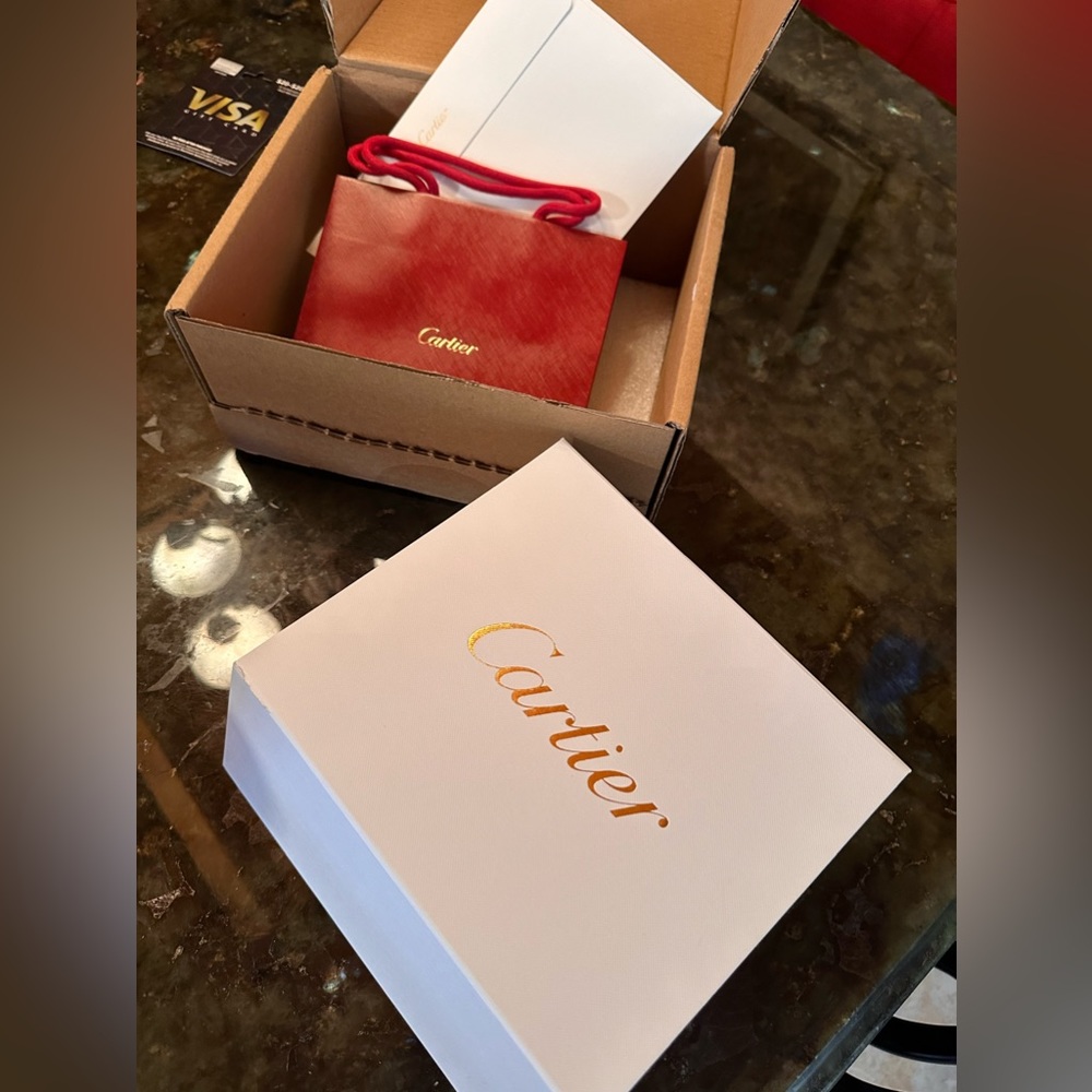 Cartier empty box with red shopping bag and cartier envelope return card.